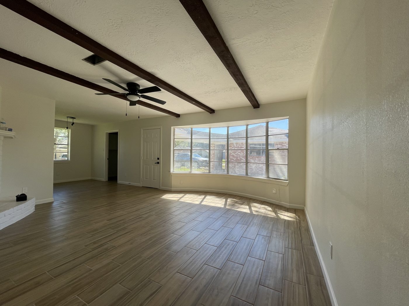 The same living room finished, with the original ceiling beams retained